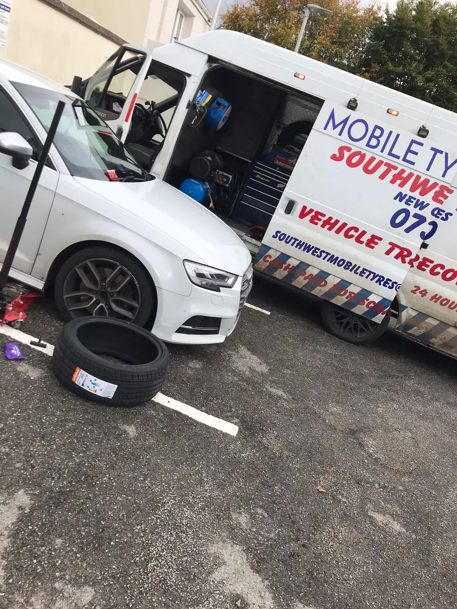 A new tyre ready to be fitted next to the Southwest Mobile Tyres van