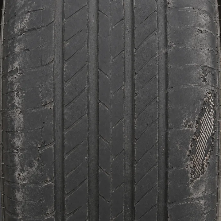 Illegally worn tyre with kerb damage and the cords showing